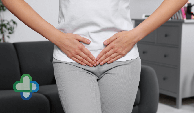 woman with cystitis holding stomach - buy cheap cystitis treatment online - the family chemist