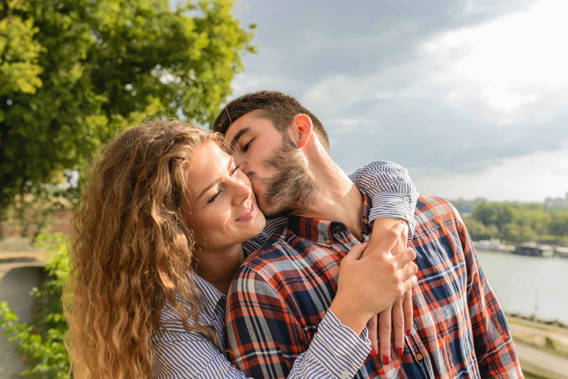 Man kissing woman's cheek