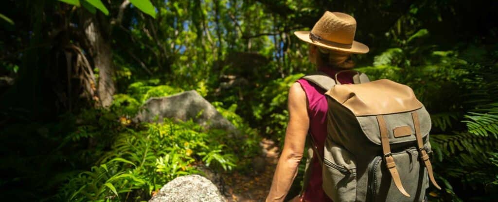 Woman hiking at the jungle with anti malaria treatments in the UK