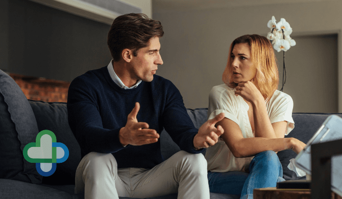 couple discussing erectile dysfunction on the sofa - buy cheap erectile dysfunction treatment online - the family chemist