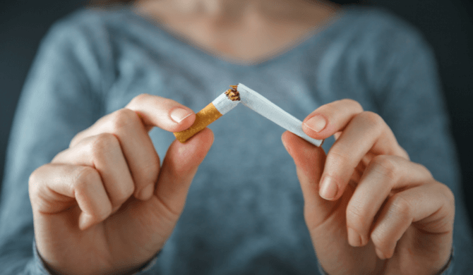 woman who has quit smoking with the help of zyban snapping cigarette in half | Buy zyban online