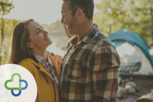 happy couple smiling while camping