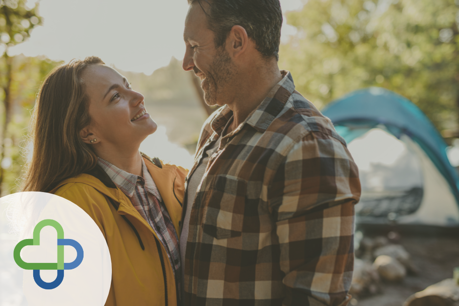 happy couple smiling while camping