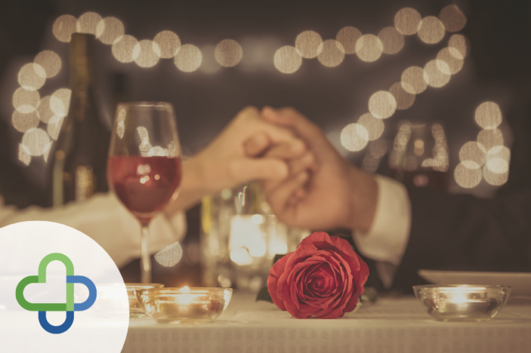 feature pic of a couple holding hands over dinner