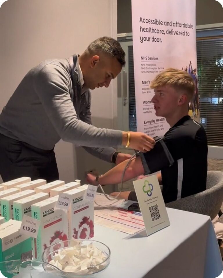 Man taking person's blood pressure