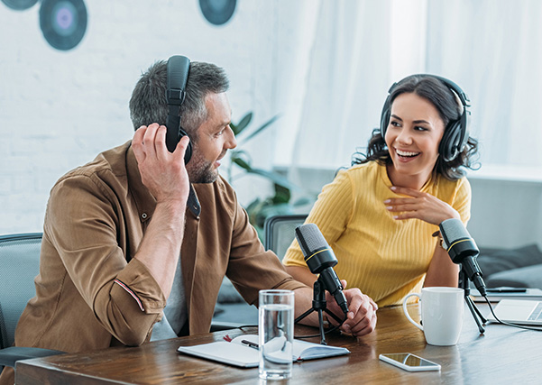 two people smiling and doing a podcast on nutrition
