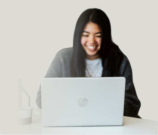 woman on a laptop smiling, doing a nutritional coaching video call