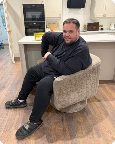 Actor and Influencer George Keywood after his weight loss transformation sat down wearing a black tracksuit